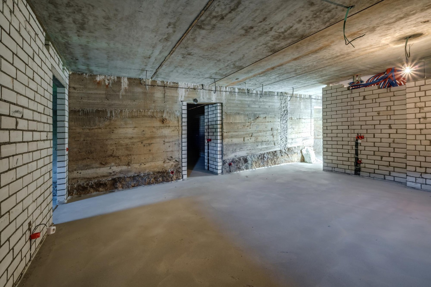 empty-basement-room-with-minimal-preparatory-repairs-interior-with-white-brick-walls (1)